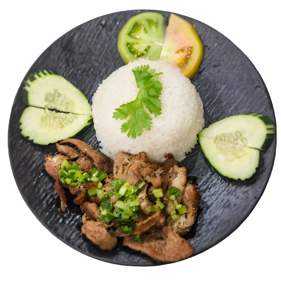 Vietnamese grilled pork with rice, cucumbers, and tomatoes on a black plate.